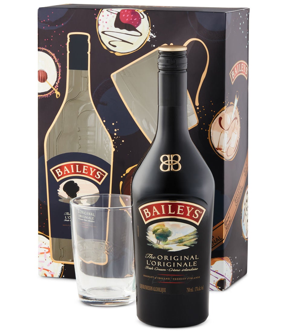 A bottle of Baileys and a glass in front of a gift box