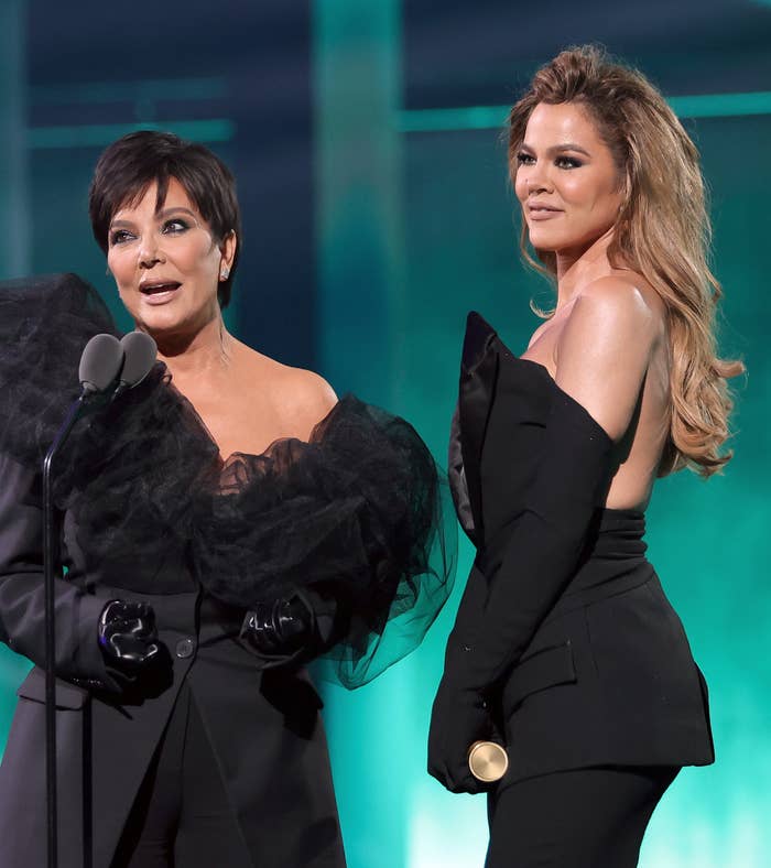 khloe and kris accepting an award on stage