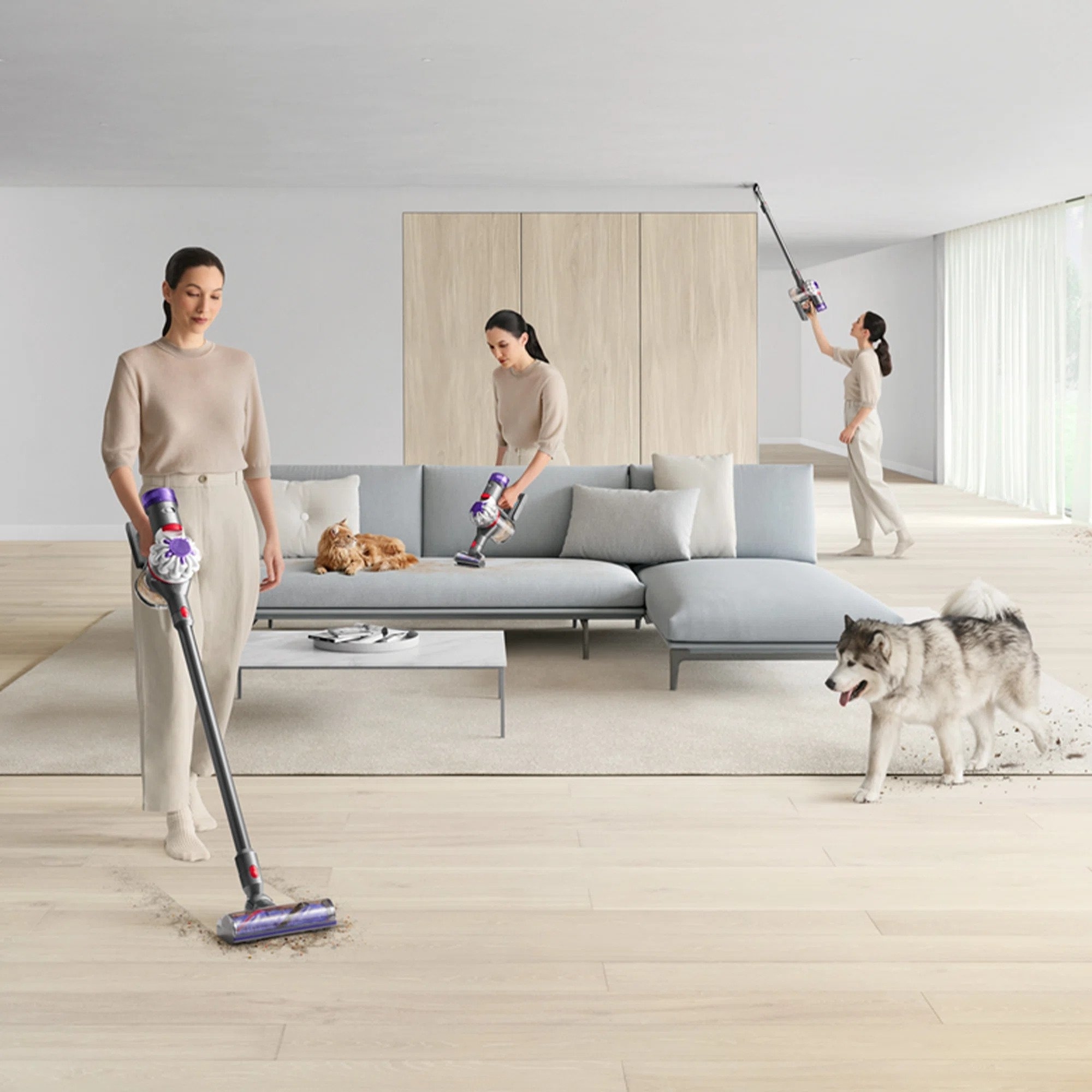 A model using the stick vacuum in three ways; regular, handheld, and with an attachment to clean the ceiling