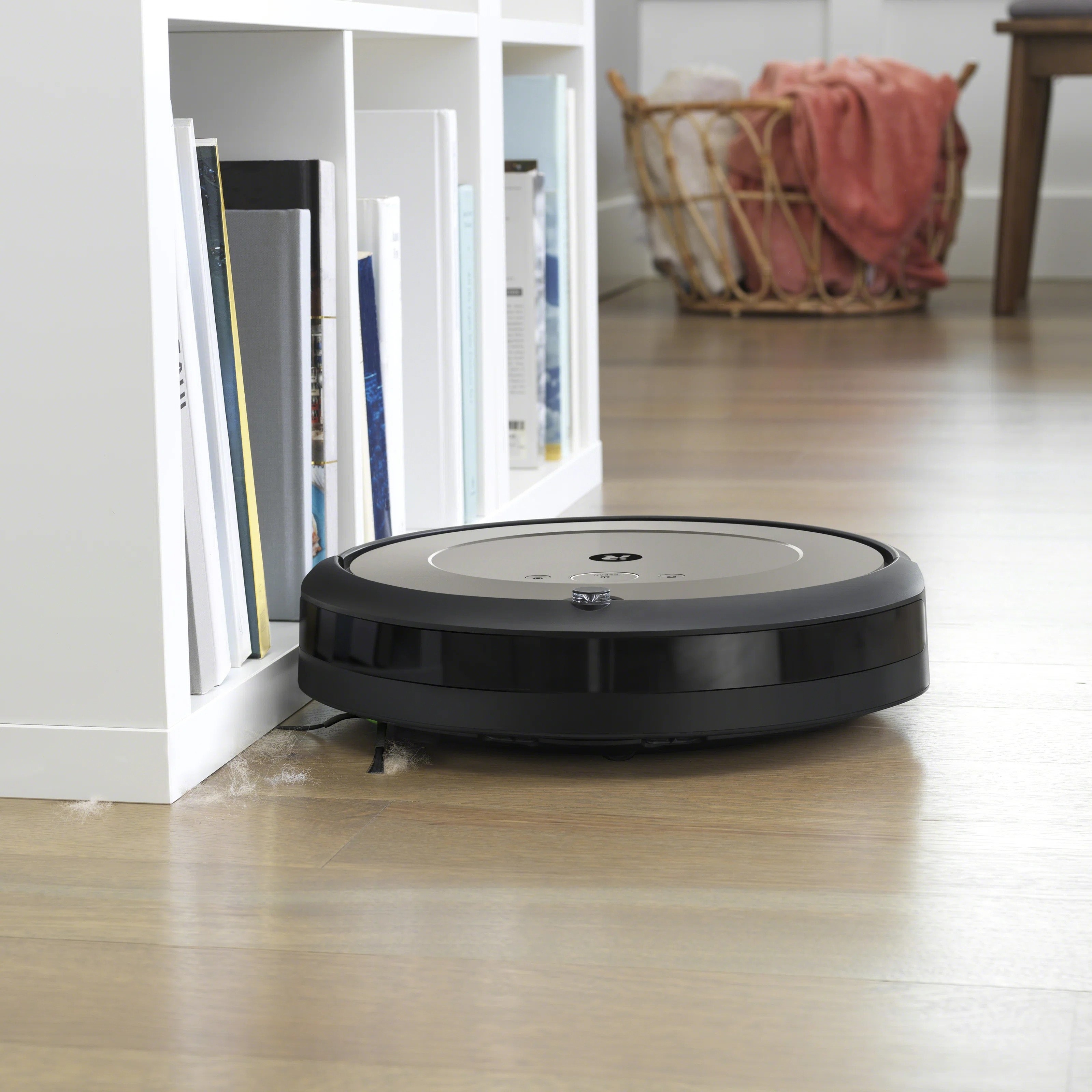 The disc-shaped Roomba on the floor