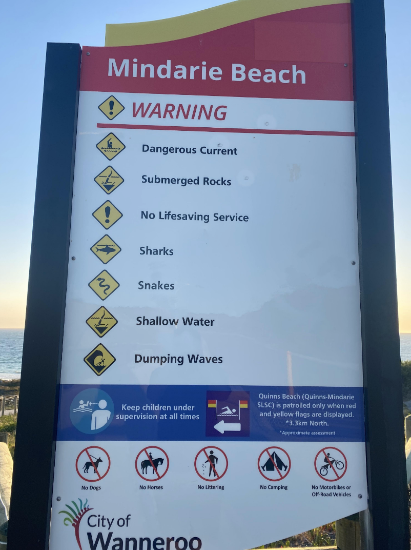 A warning sign at a beach