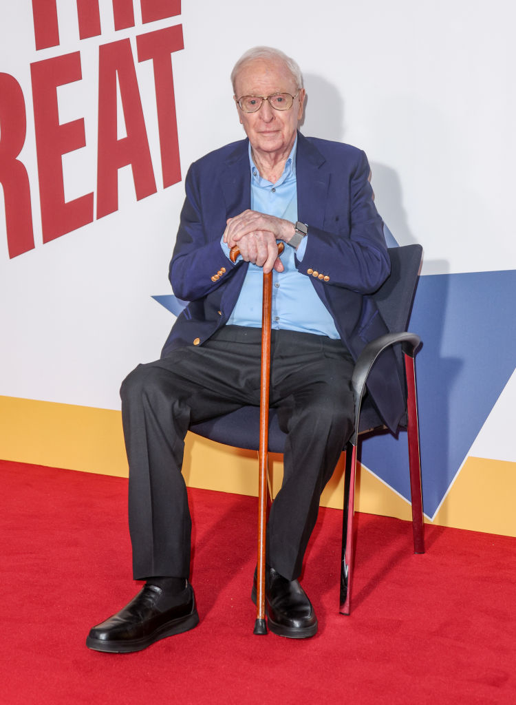 closeup of him on the red carpet sitting down with his cane