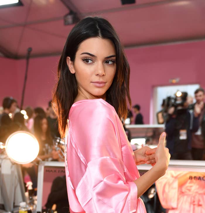 Closeup of Kendall Jenner in a satin robe backstage of a fashion show