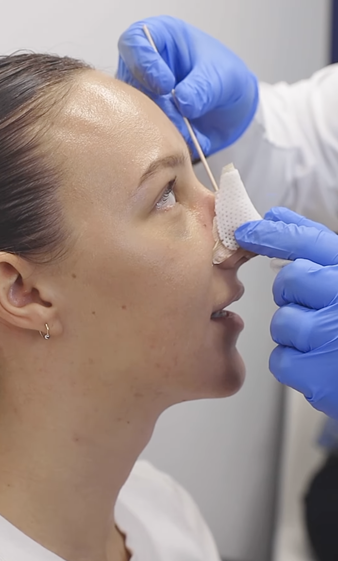closeup of a doctor working on her nose
