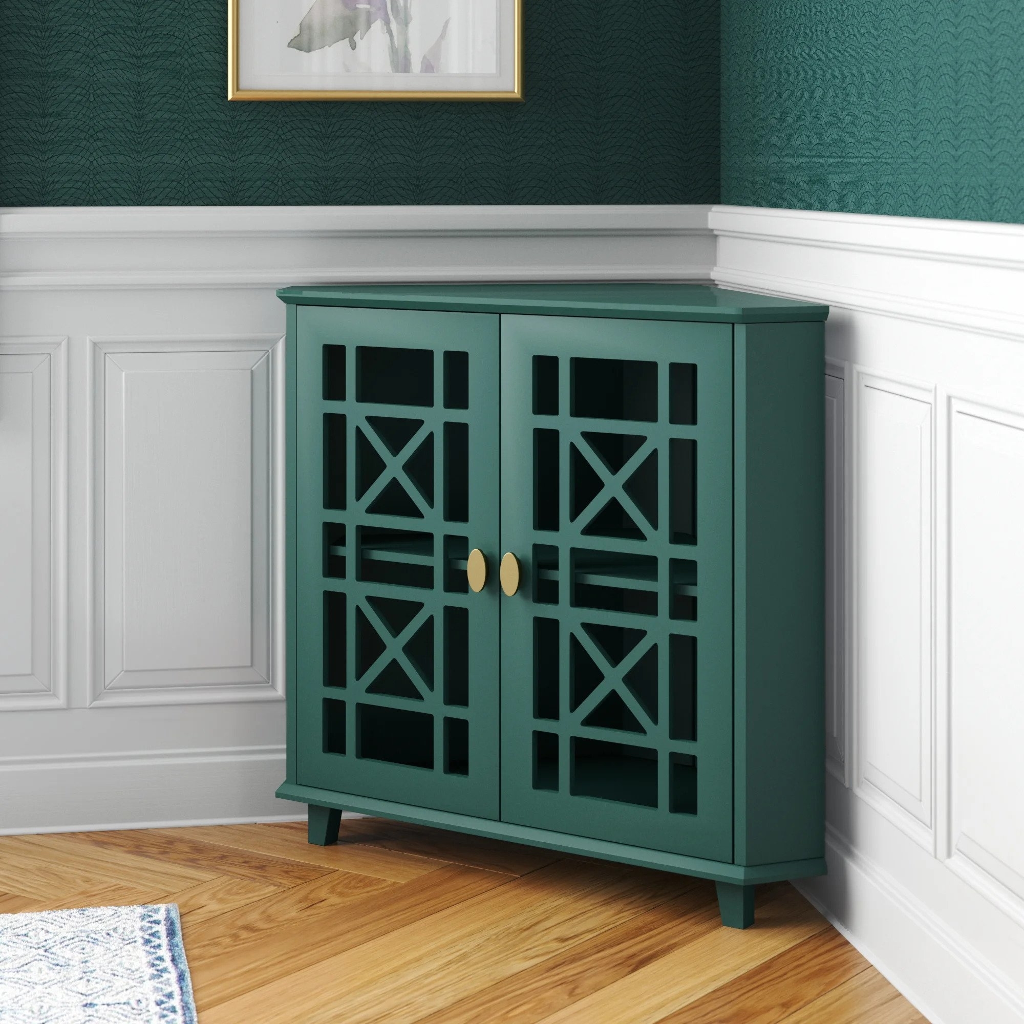 The V-shaped cabinet in teal, featuring an openwork trellis design on the doors, brass knobs, and a teal finish