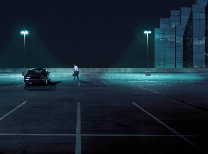 A person in a dark parking lot
