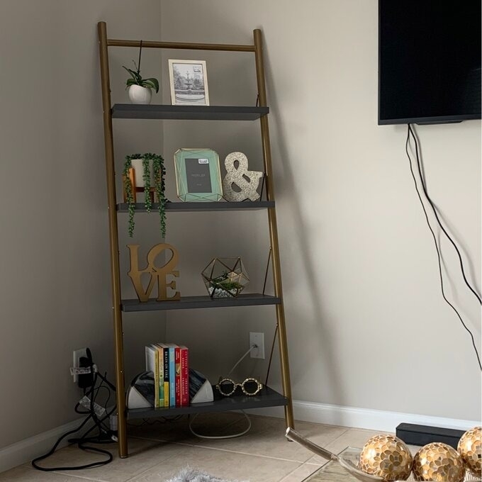 A ladder bookcase in a living room