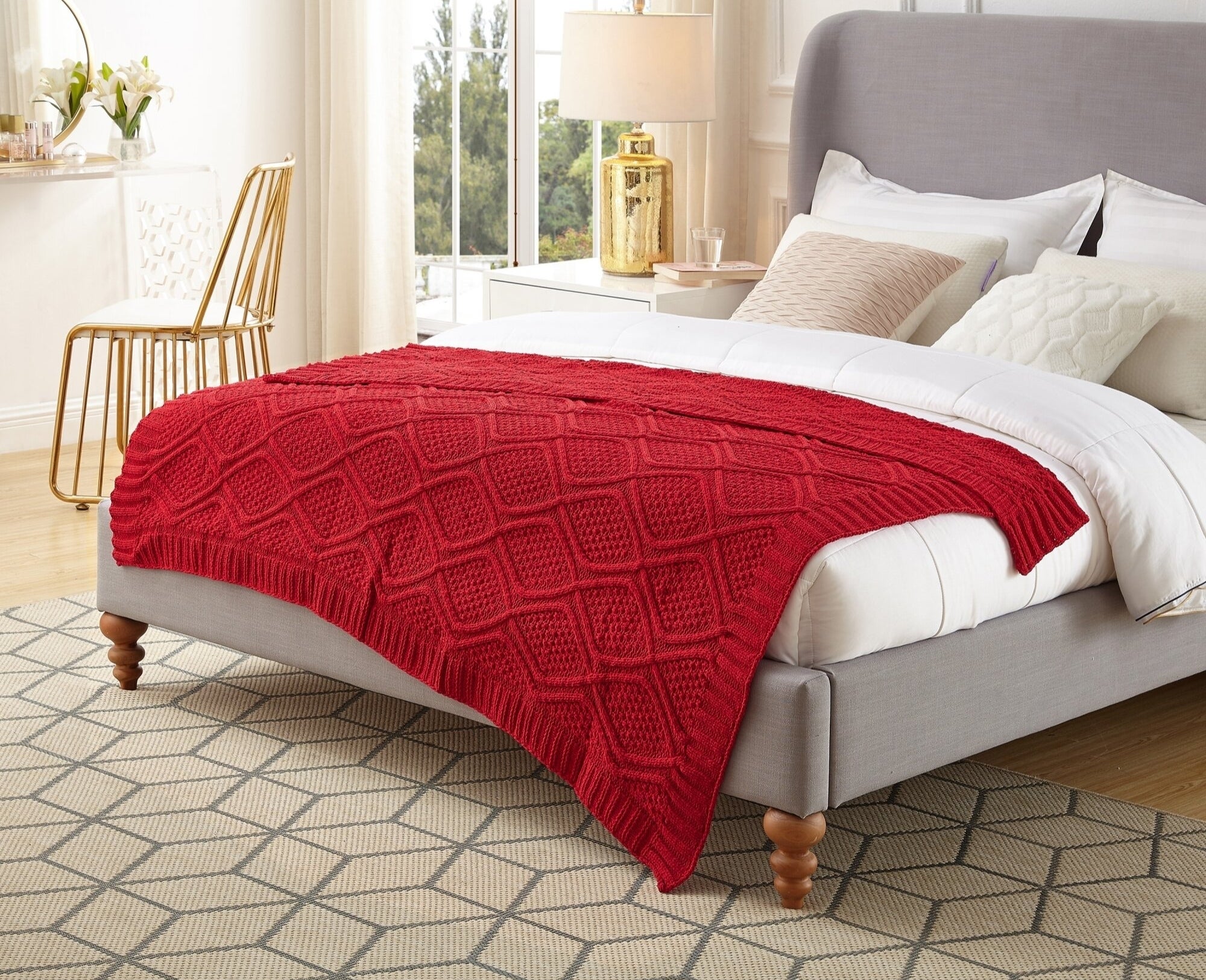 A knitted throw blanket on a bed