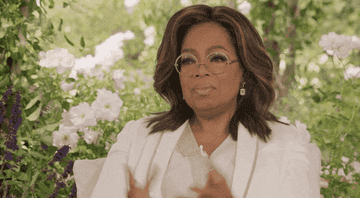 Oprah outstretching her hands.