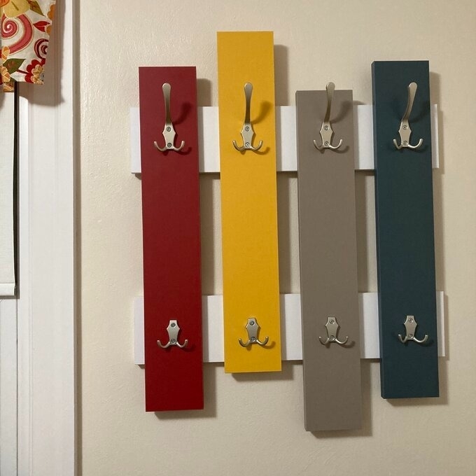 A multicolored coat rack in a hallway