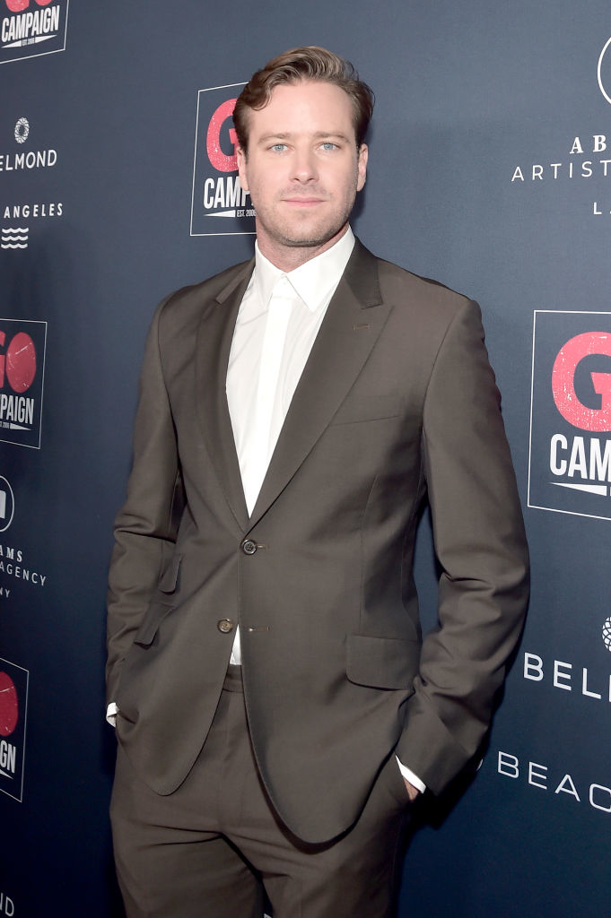Close-up of Armie at a media event wearing a suit