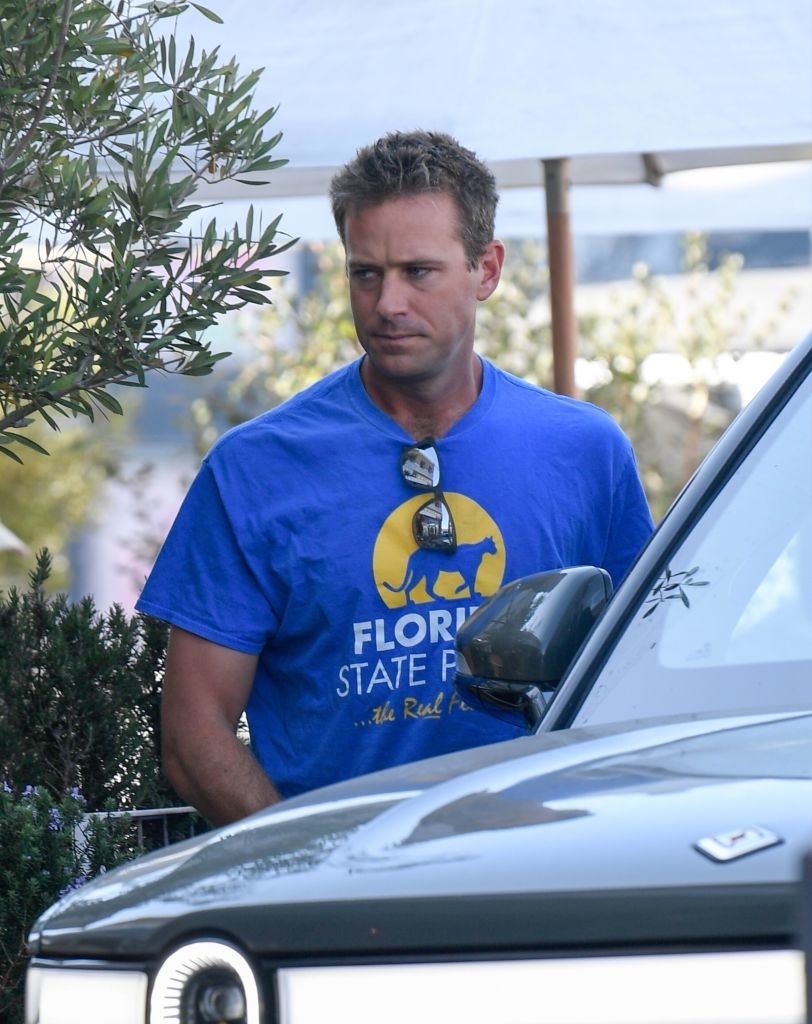 Close-up of Armie in a T-shirt by a car