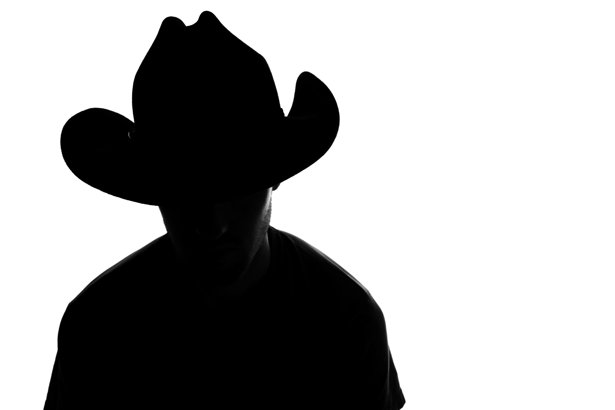 Silhouette of a person wearing a Western-style hat
