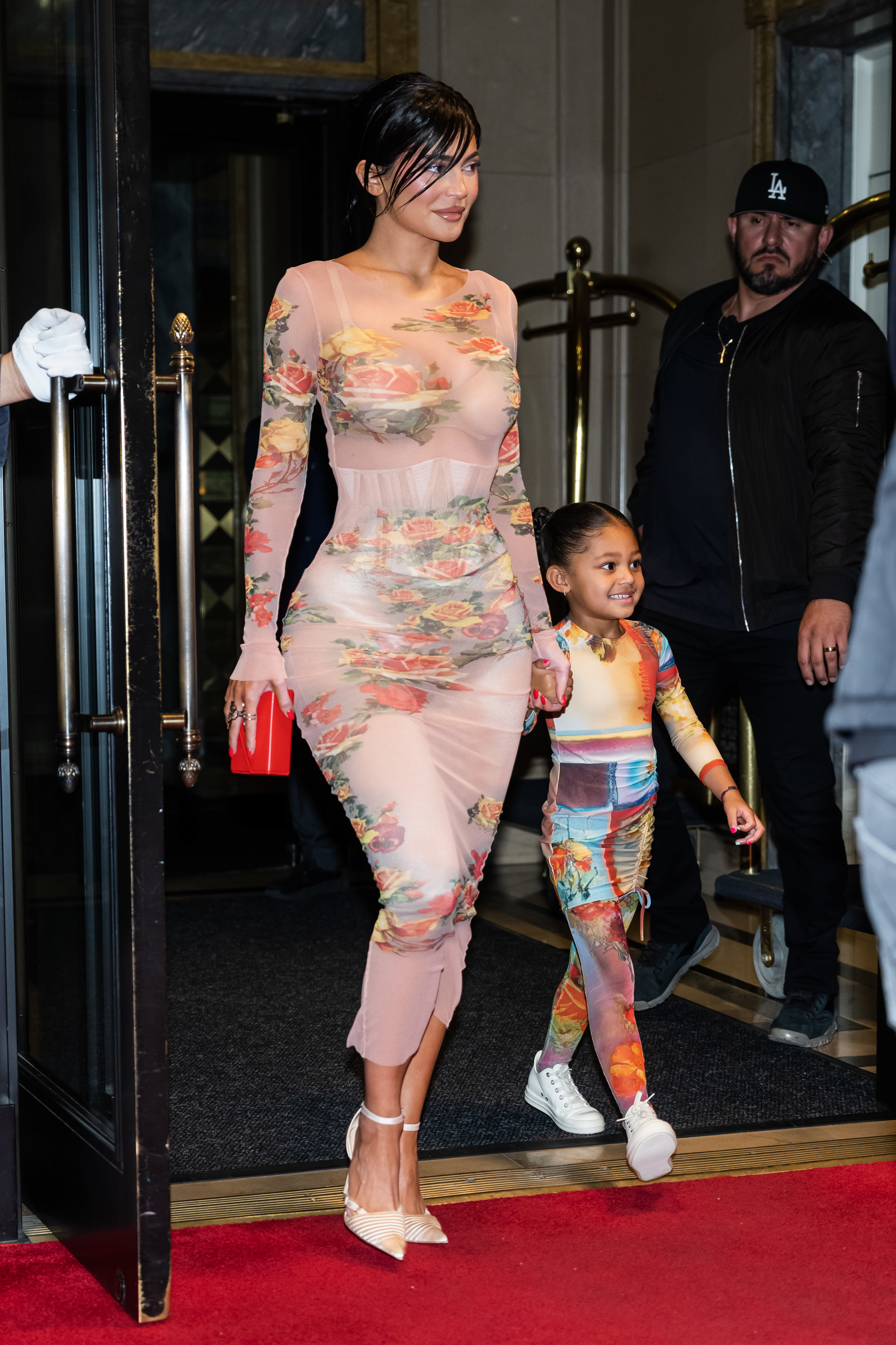 Kylie and Stormi exiting a building