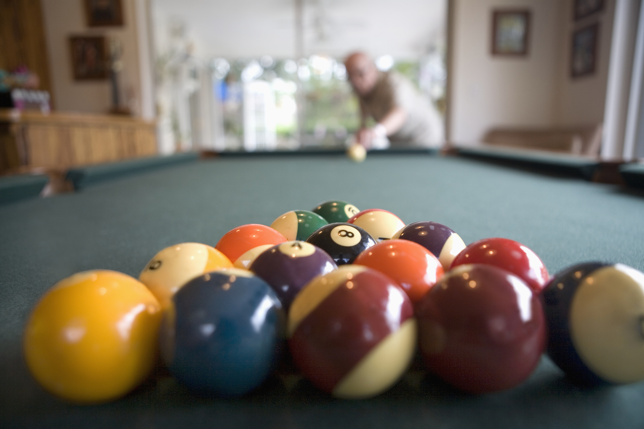 A man is playing billiards