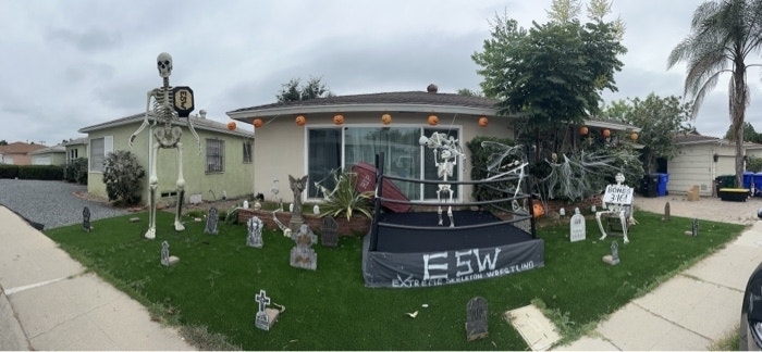 A wrestling ring with skeletons inside and in the audience set up in front of a house