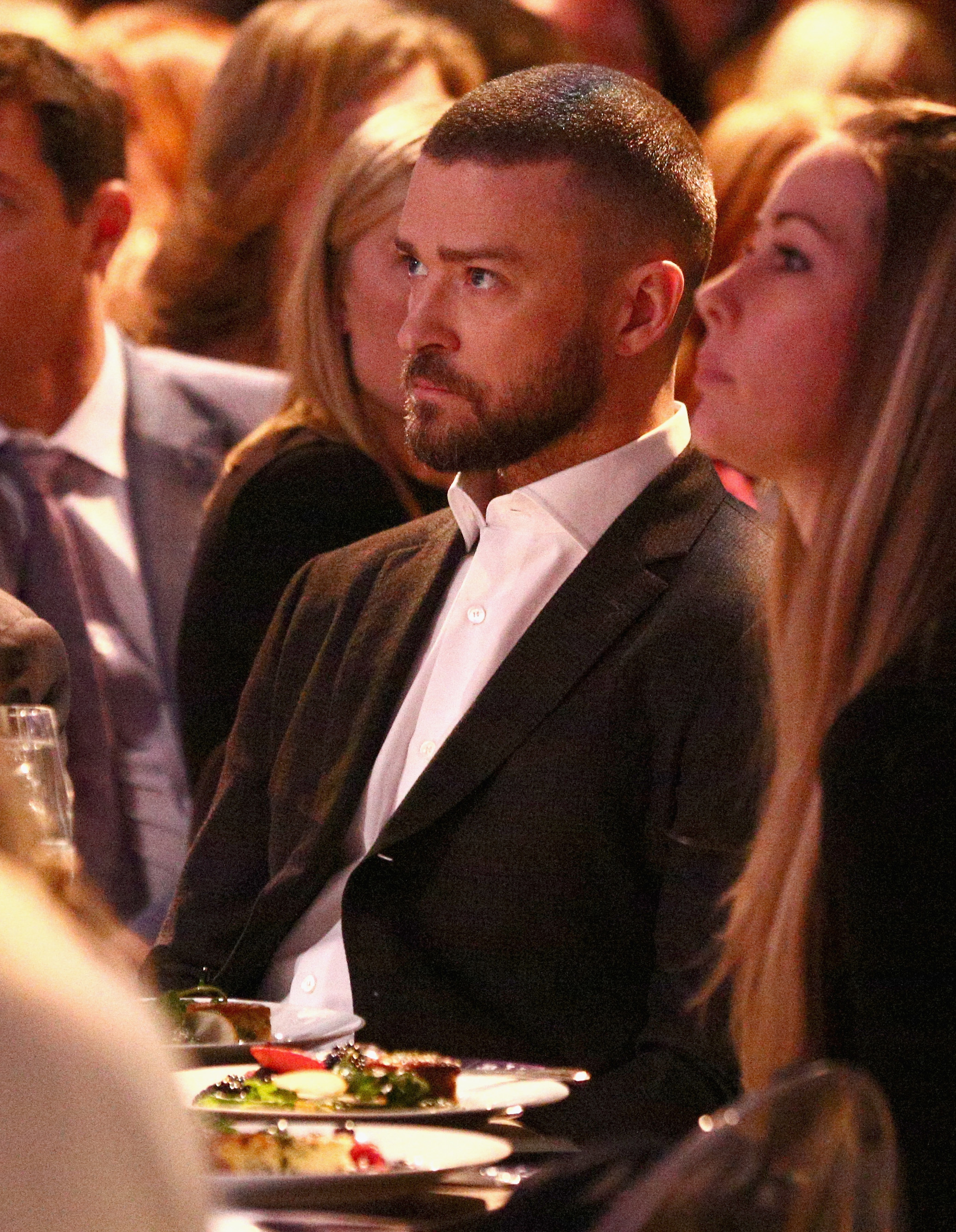 Close-up of Justin looking serious and sitting at a table