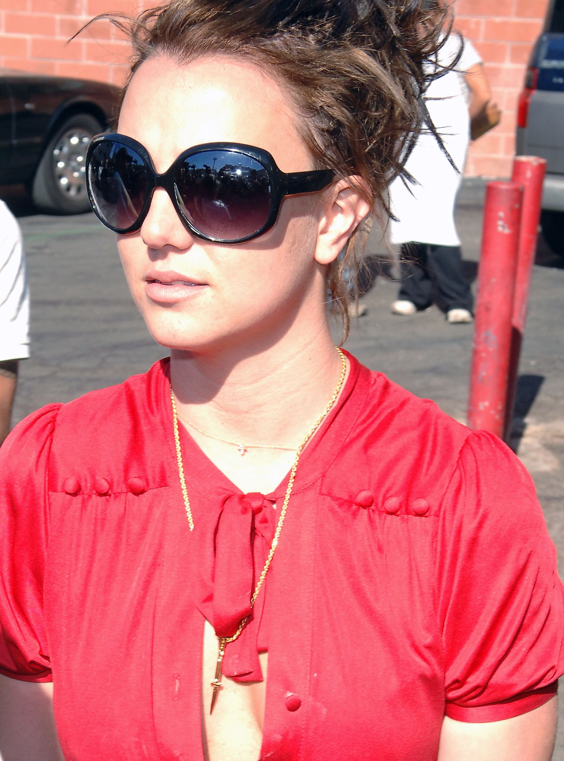 Close-up of Britney outside wearing sunglasses and her hair up