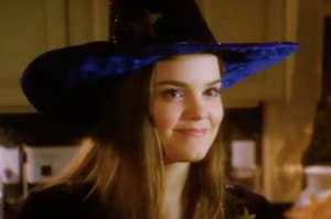 Marnie, a teen witch in Disney Channel's "Halloweentown," smiles slightly with her lips closed. She wears a witch hat.