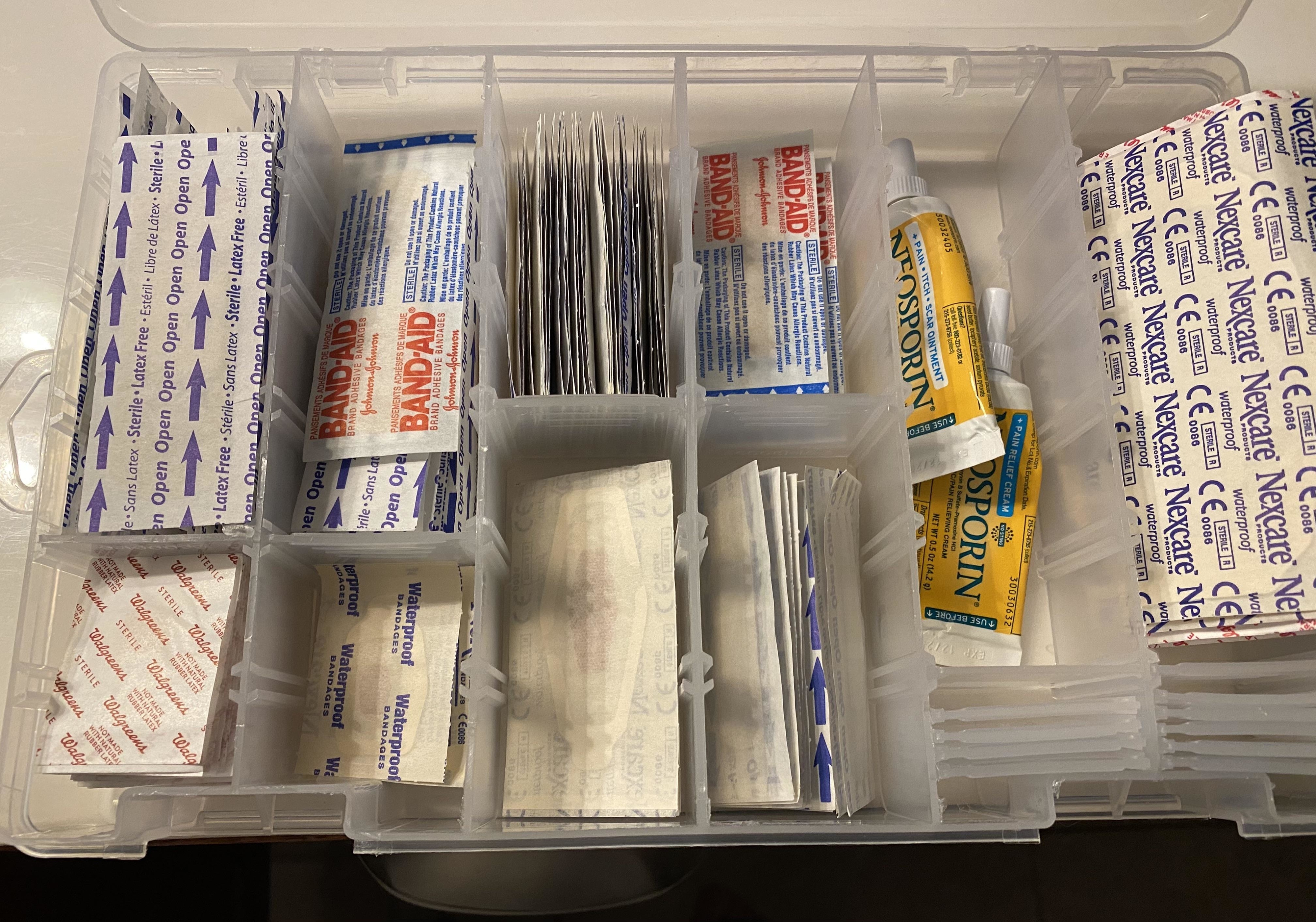 A bin full of every type of bandage, organized in clear plastic