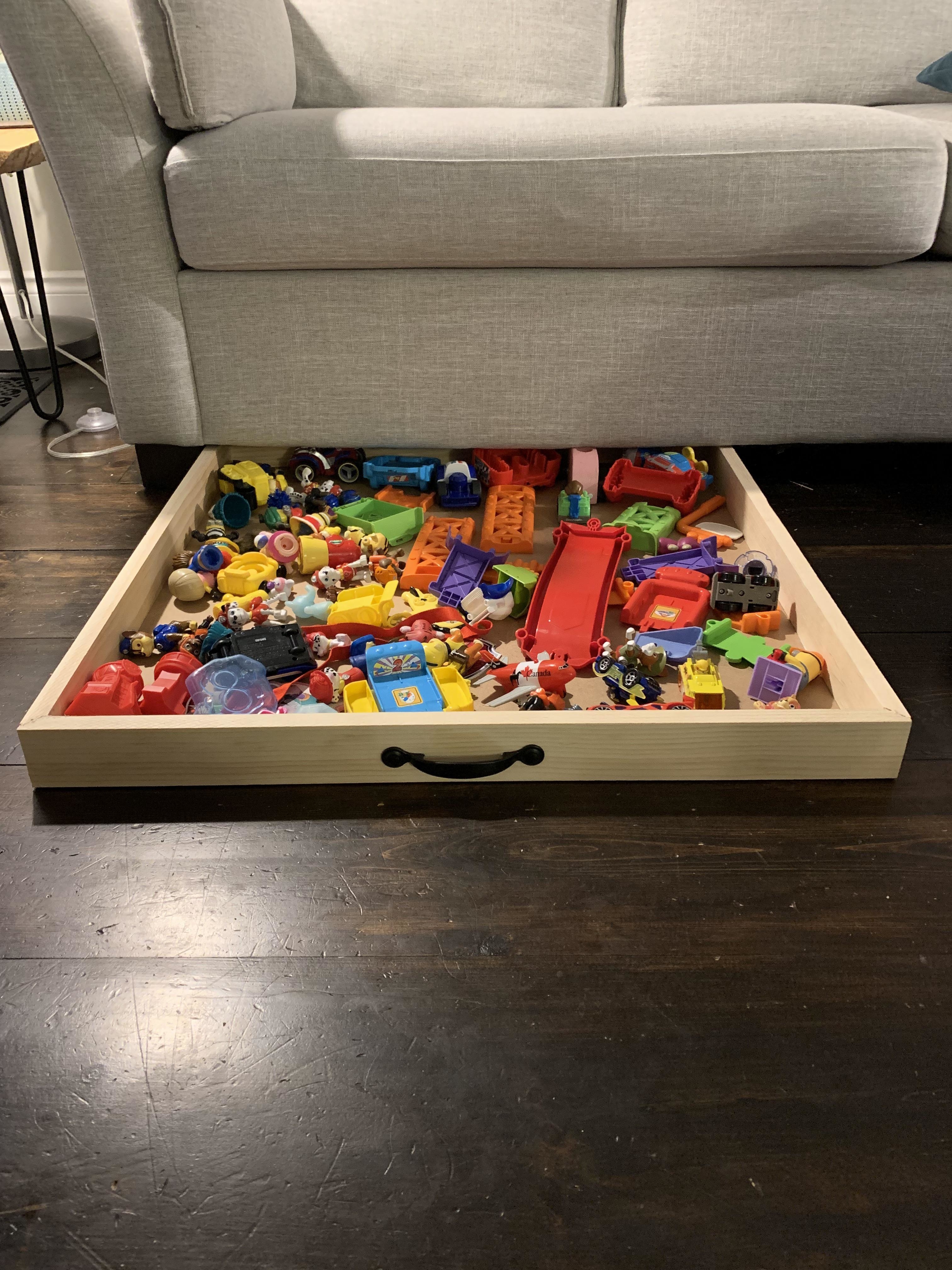 Roll-out bin under the couch to hold kids&#x27; toys