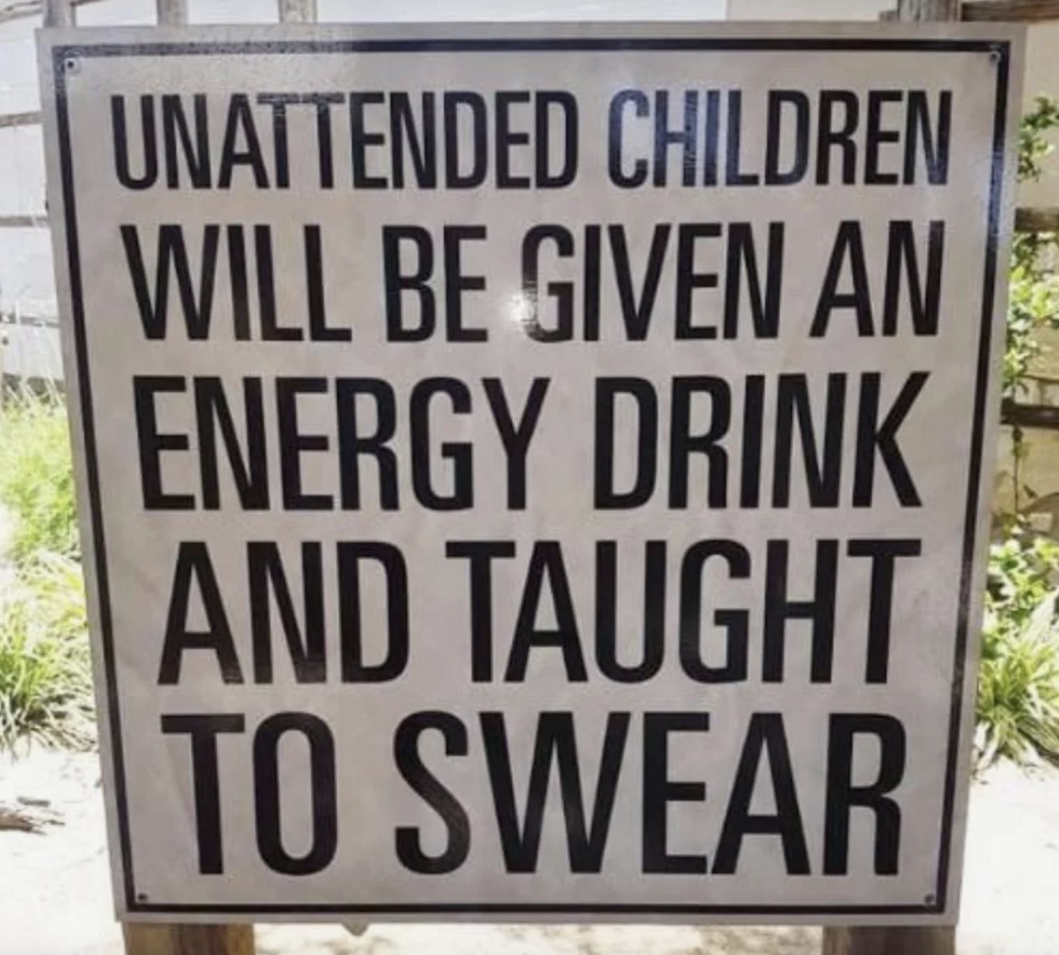 sign reading unattended children will be given an energy drink and taught to swear