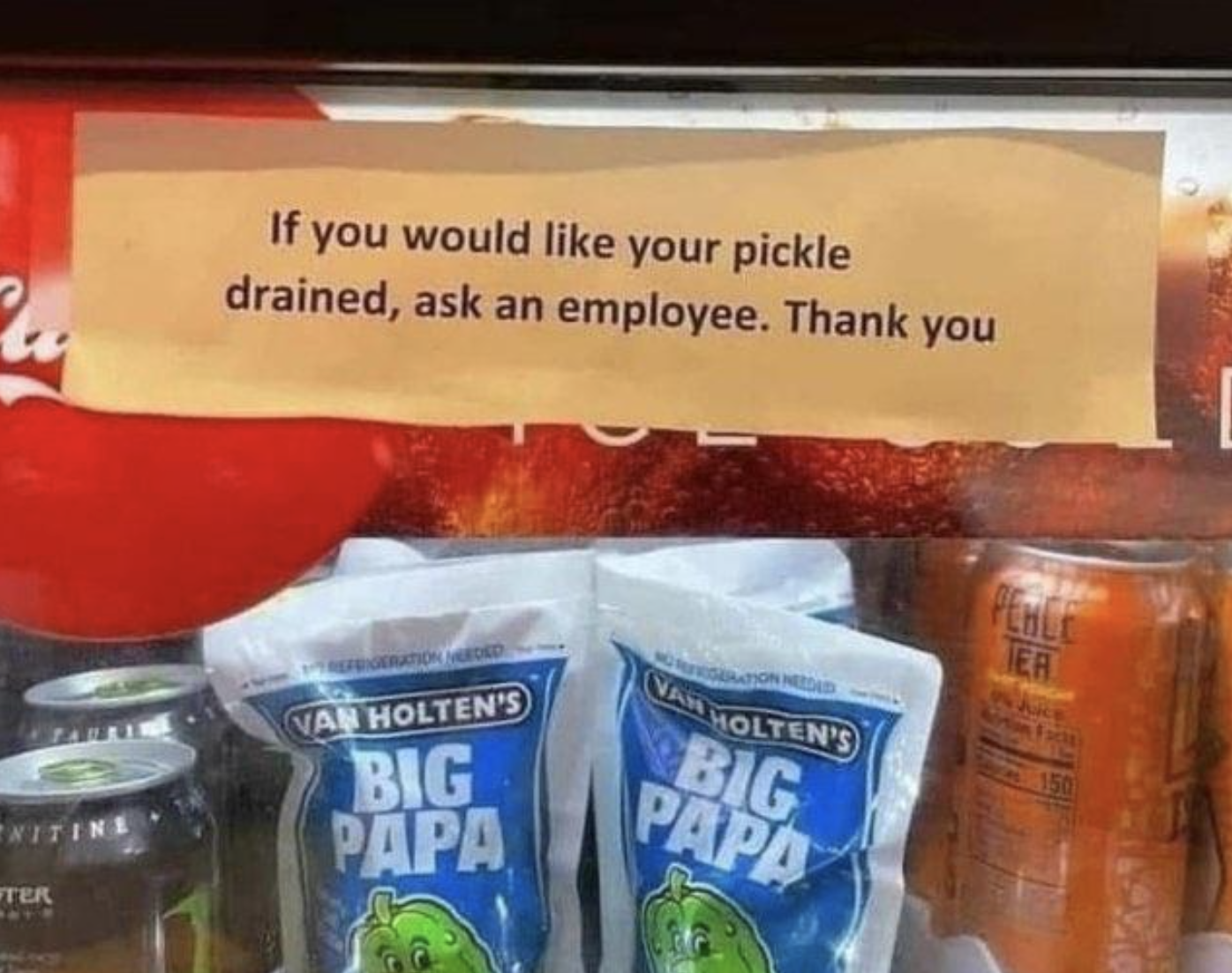 sign above pickles on the shelf reading, if you would like your pickle drained ask an employee thank you