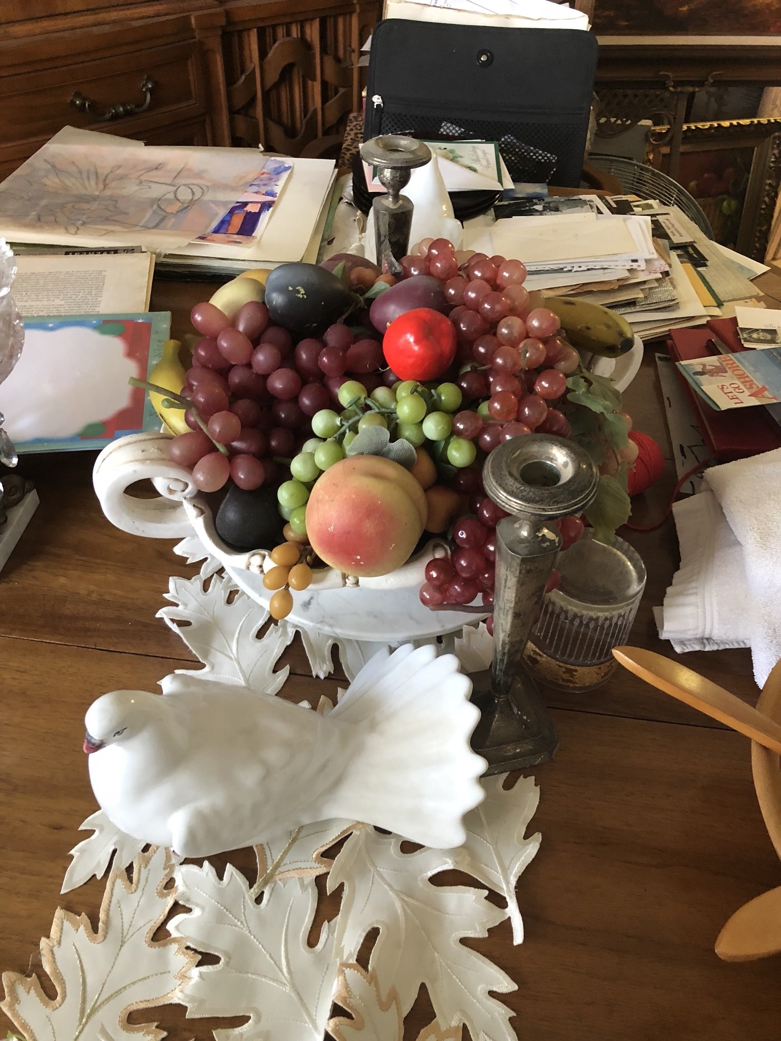 Fake fruit, including bunches of grapes, on display on a table