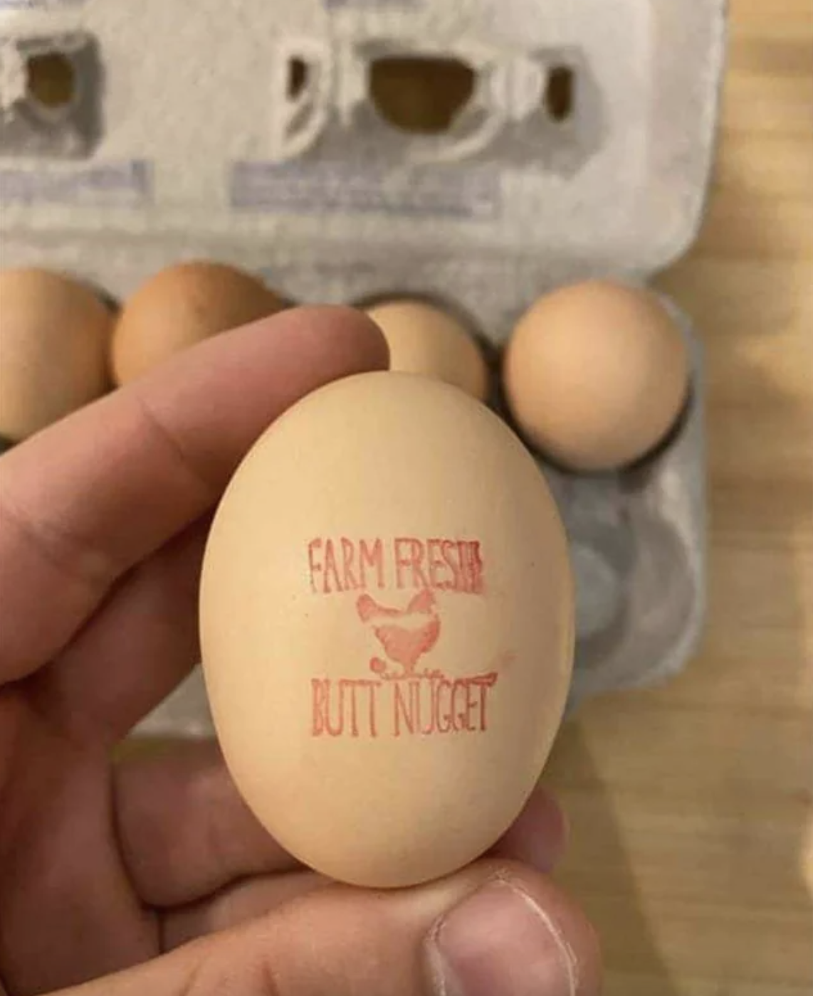 egg with a stamp reading, farm fresh butt nugget