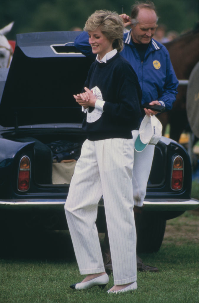 Diana, Princess of Wales (1961 - 1997) wearing a navy blue sweater and straight leg white trousers at a Guards Polo Club match at Smiths Lawn, Windsor, May 1986