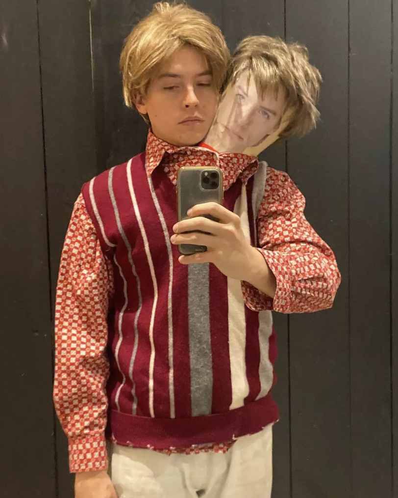 him with a paper head topped with a wig coming out of his shirt