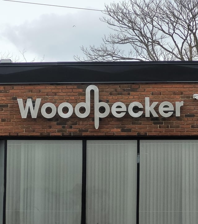 wood pecker company sign with the d and p together to look like a penis