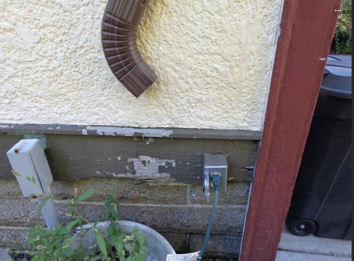 water drain on a house pointing down at an outlet