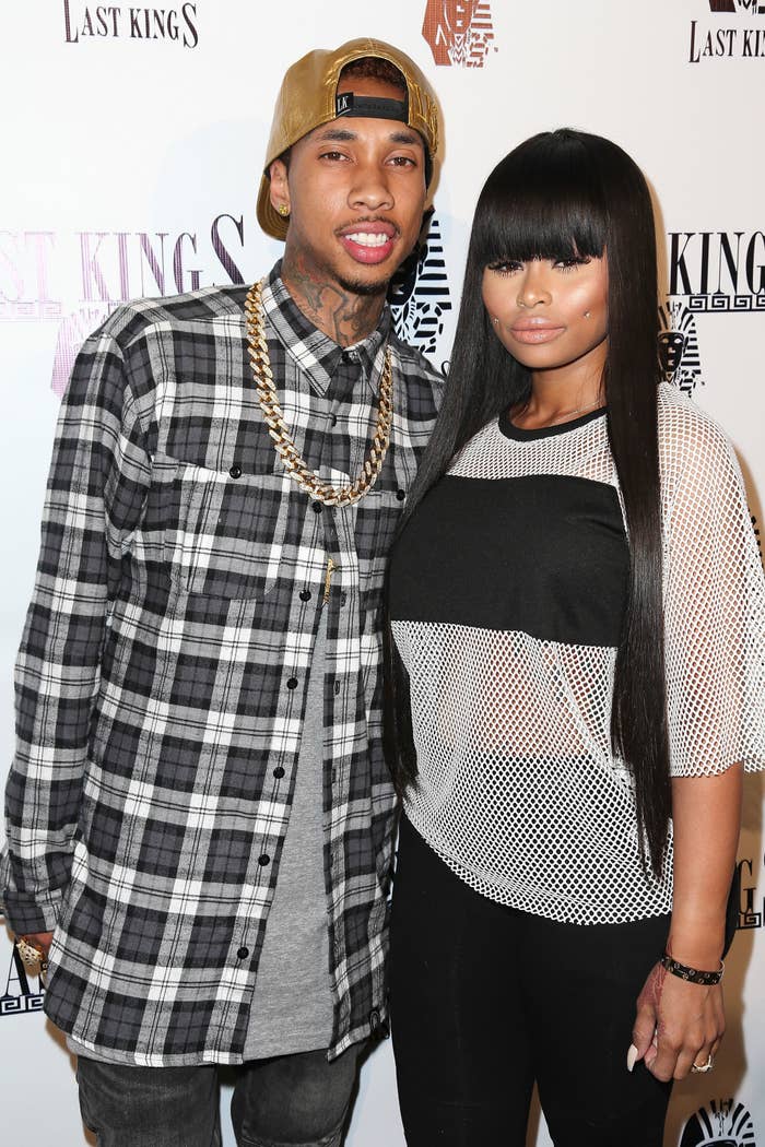 Close-up of Tyga and Angela smiling at a media event