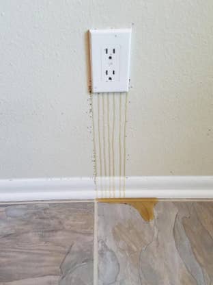 honey dripping from the outlet on a wall