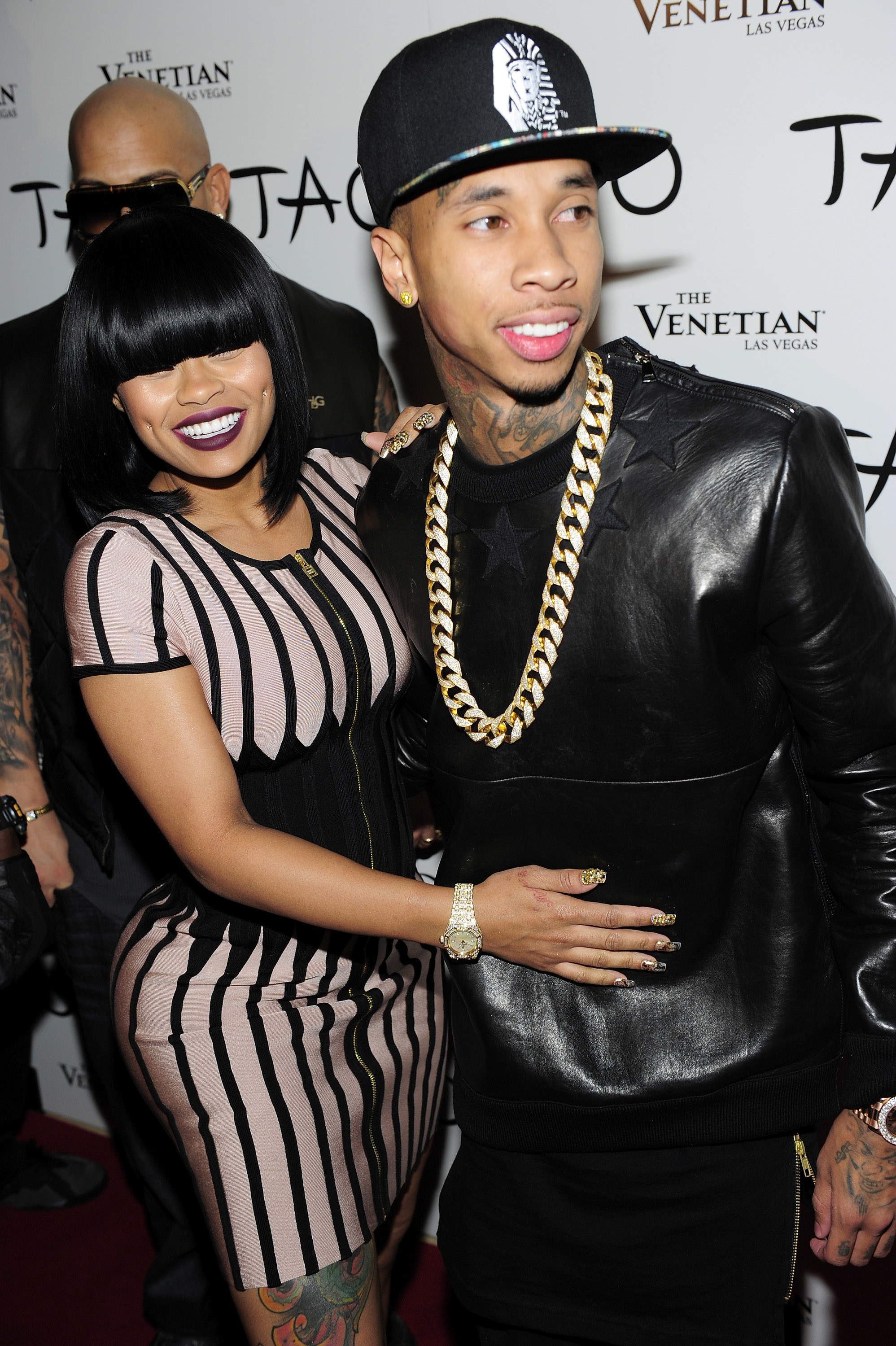 Close-up of Tyga and Angela smiling on the red carpet