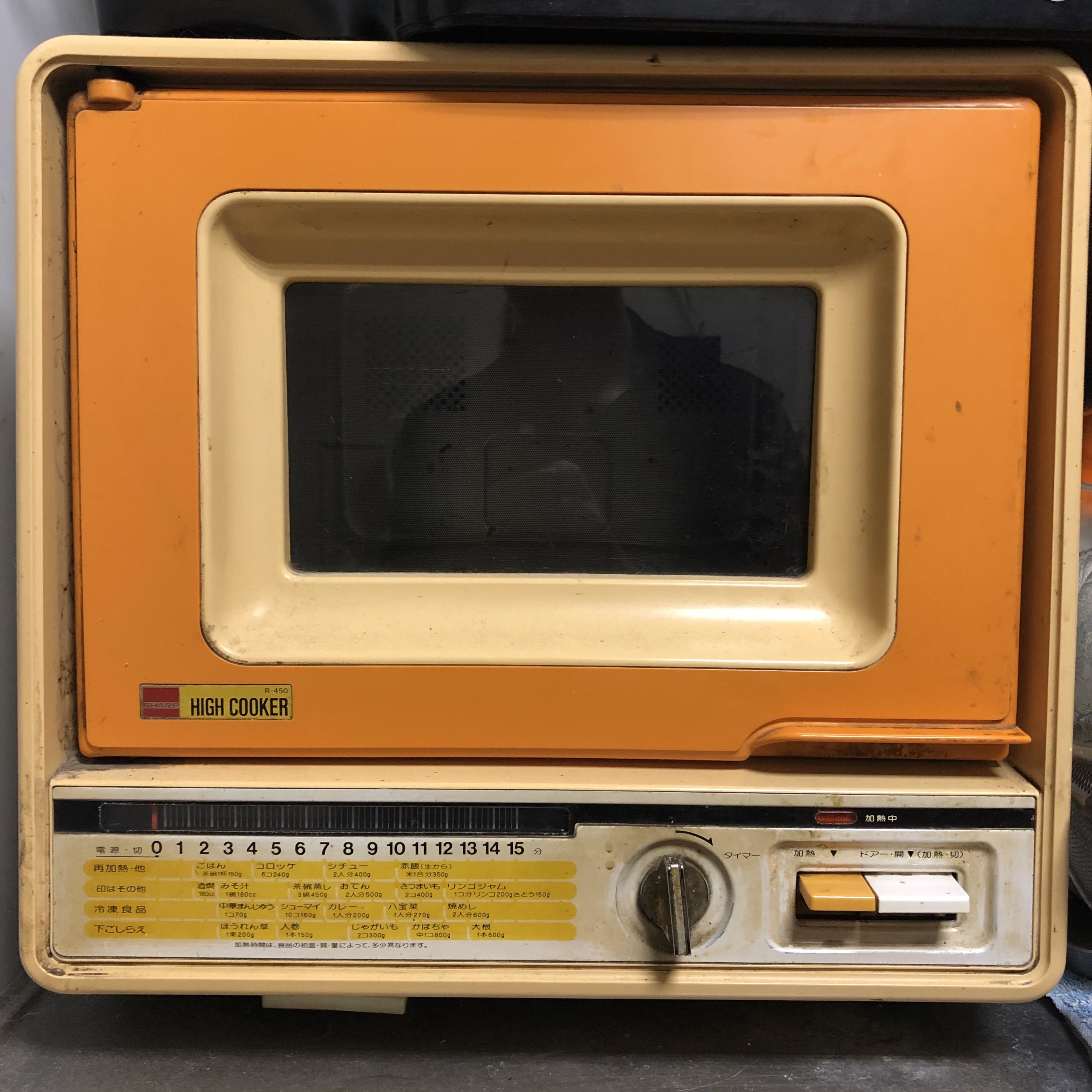 square microwave with a small viewing window and a knob for timer