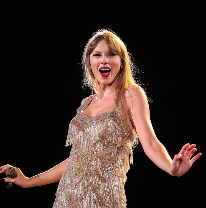 Close-up of Taylor performing and wearing a spangly, sparkly outfit