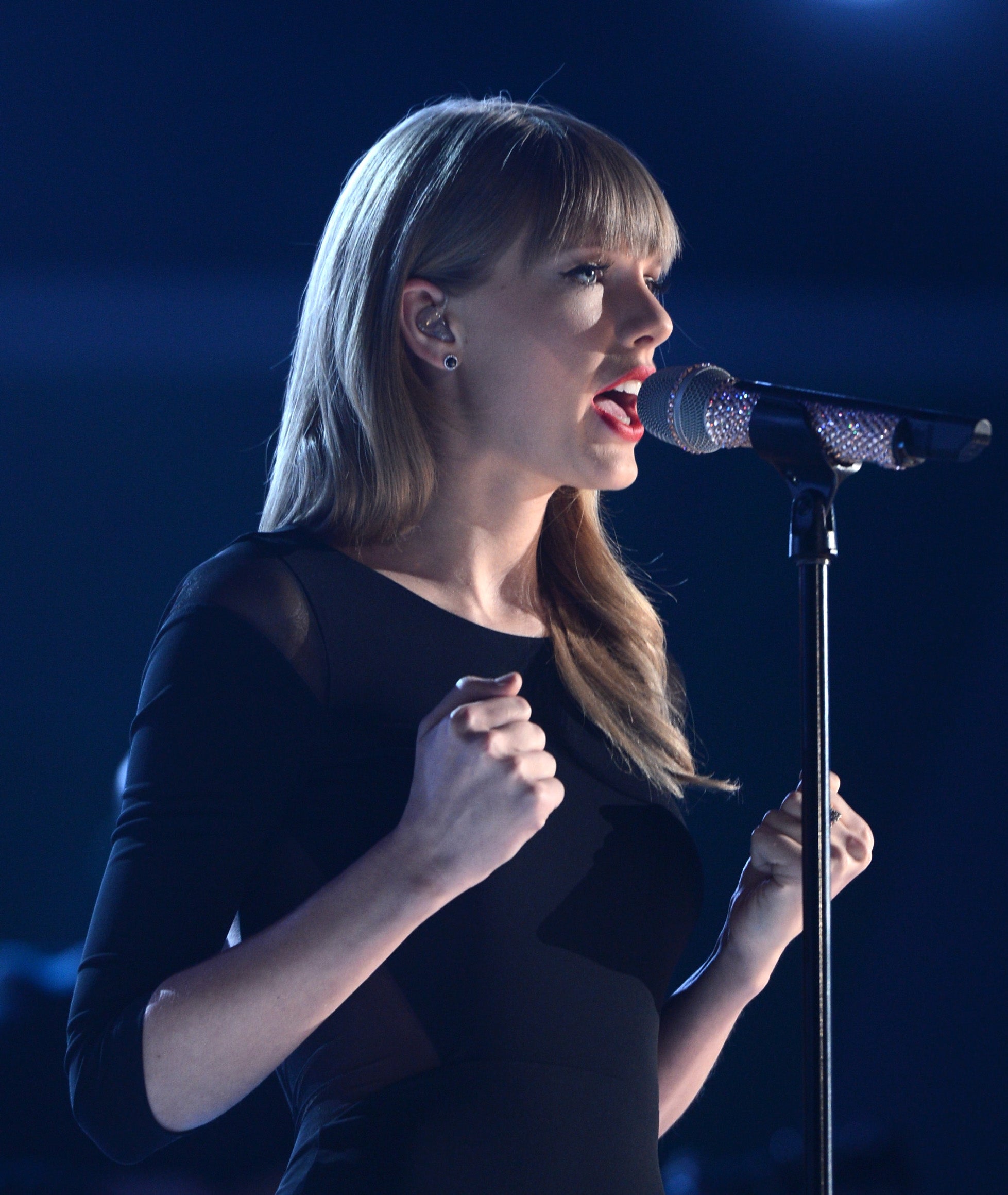 Close-up of Taylor at a microphone