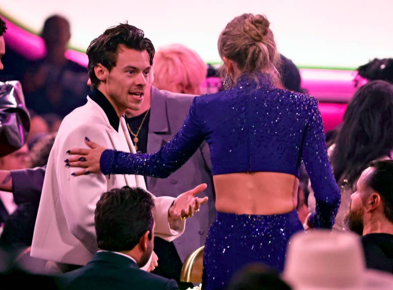 Harry and Taylor greeting each other at a media event