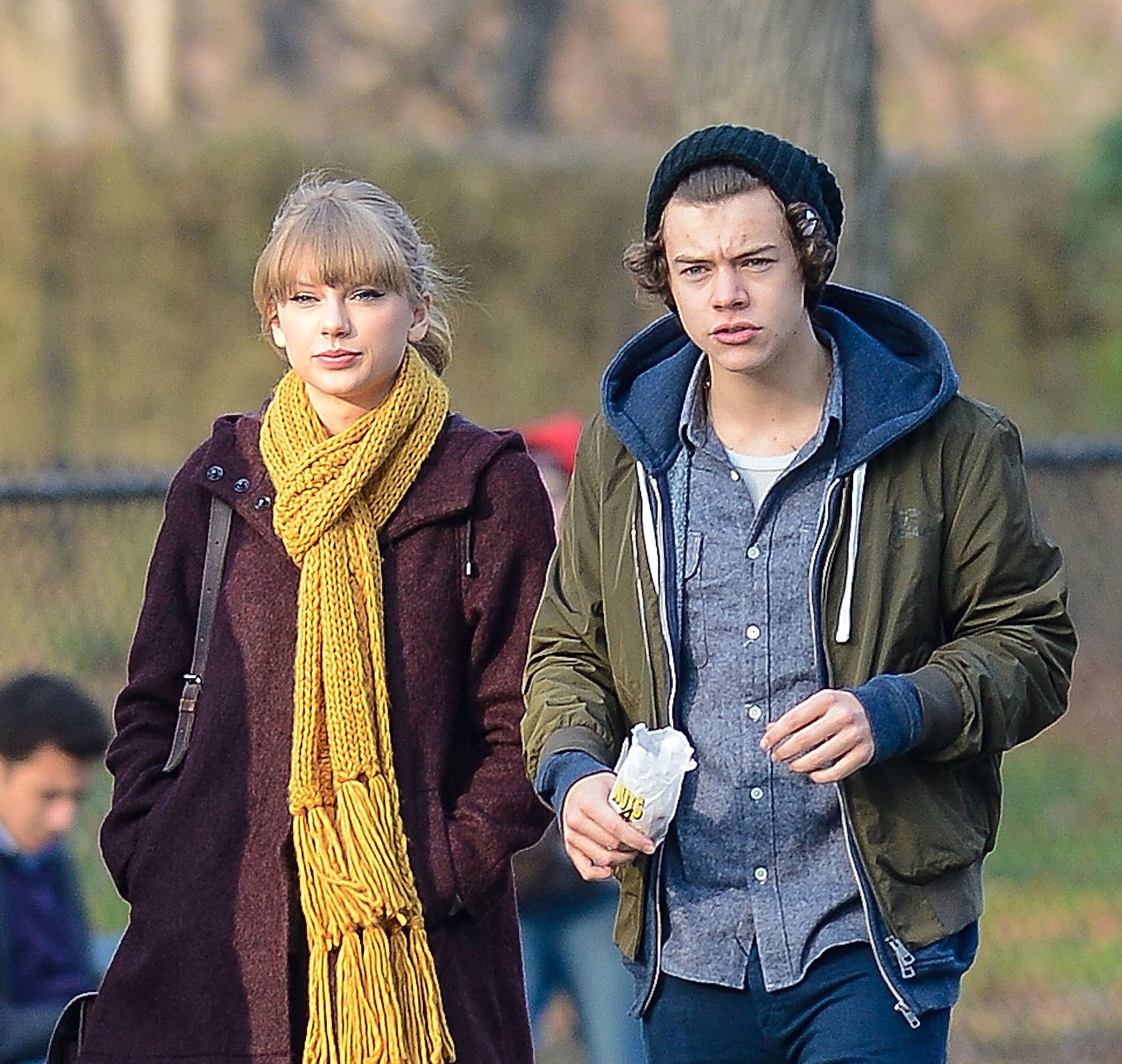 Close-up of Taylor and Harry wearing coats/jackets outside