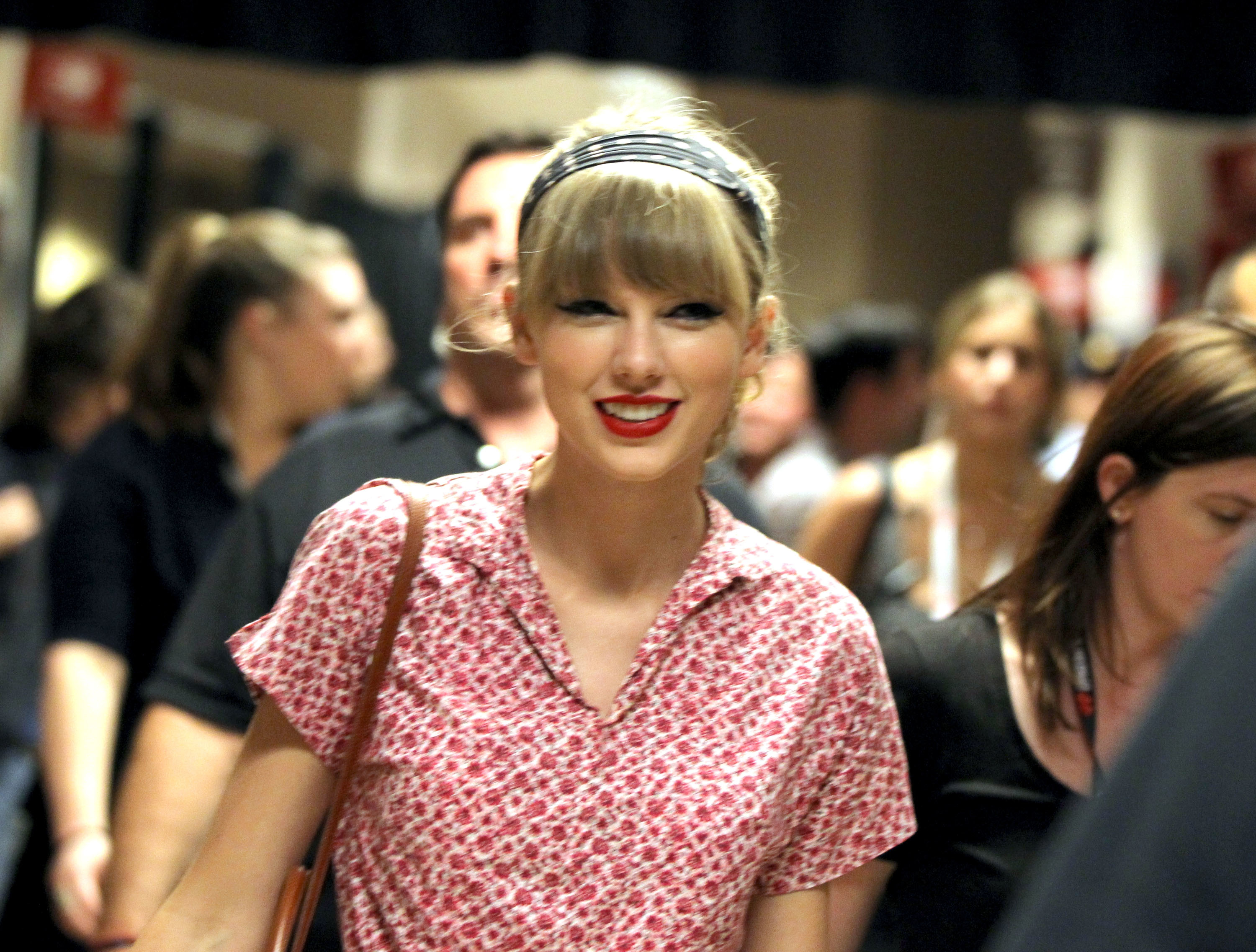 Close-up of Taylor smiling and wearing a short-sleeved blouse