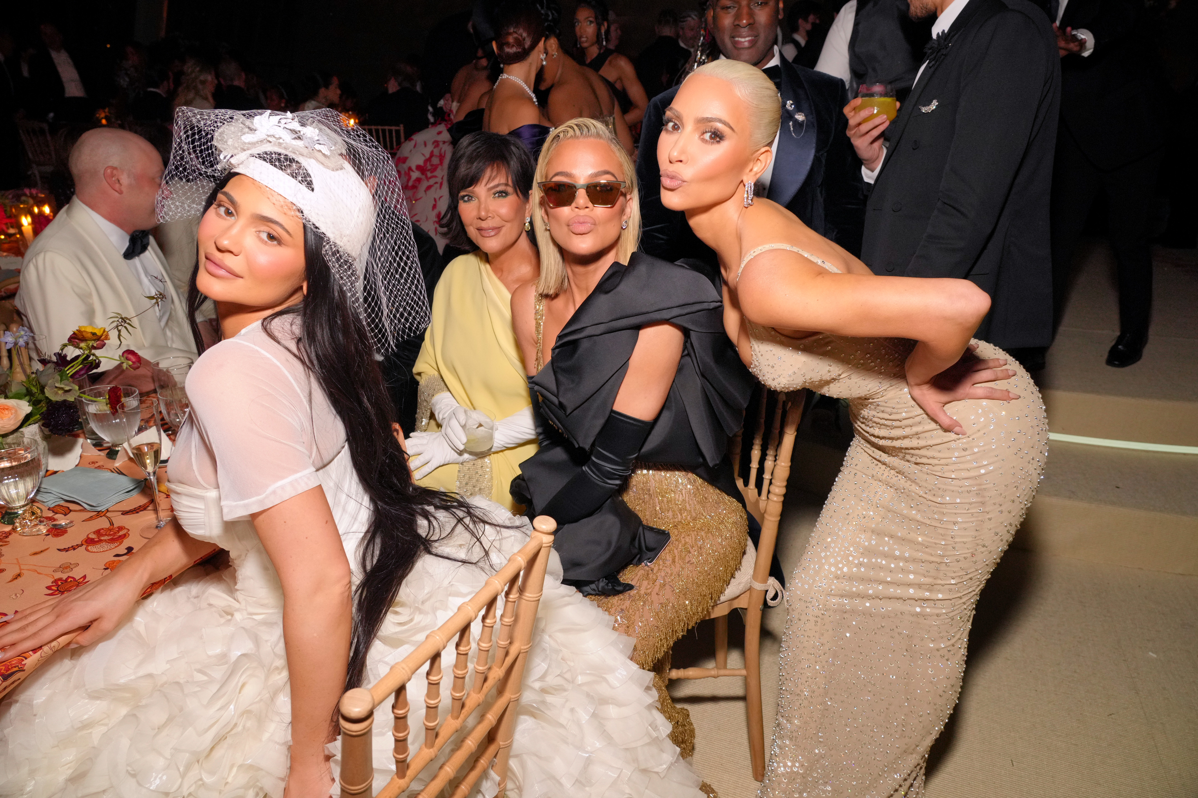 the karjenners at an event sitting at a table