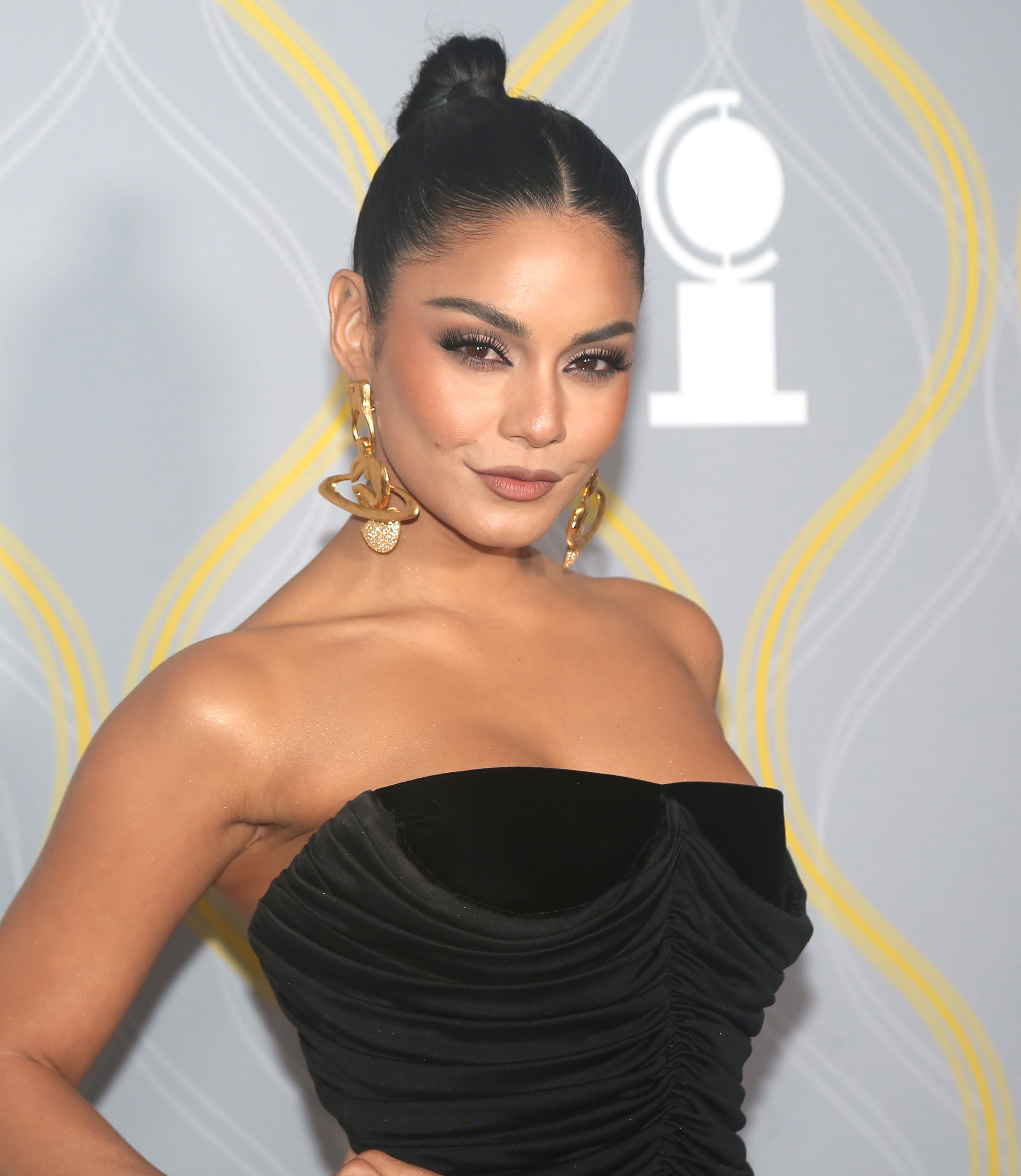 Close-up of Vanessa in a strapless outfit at a media event
