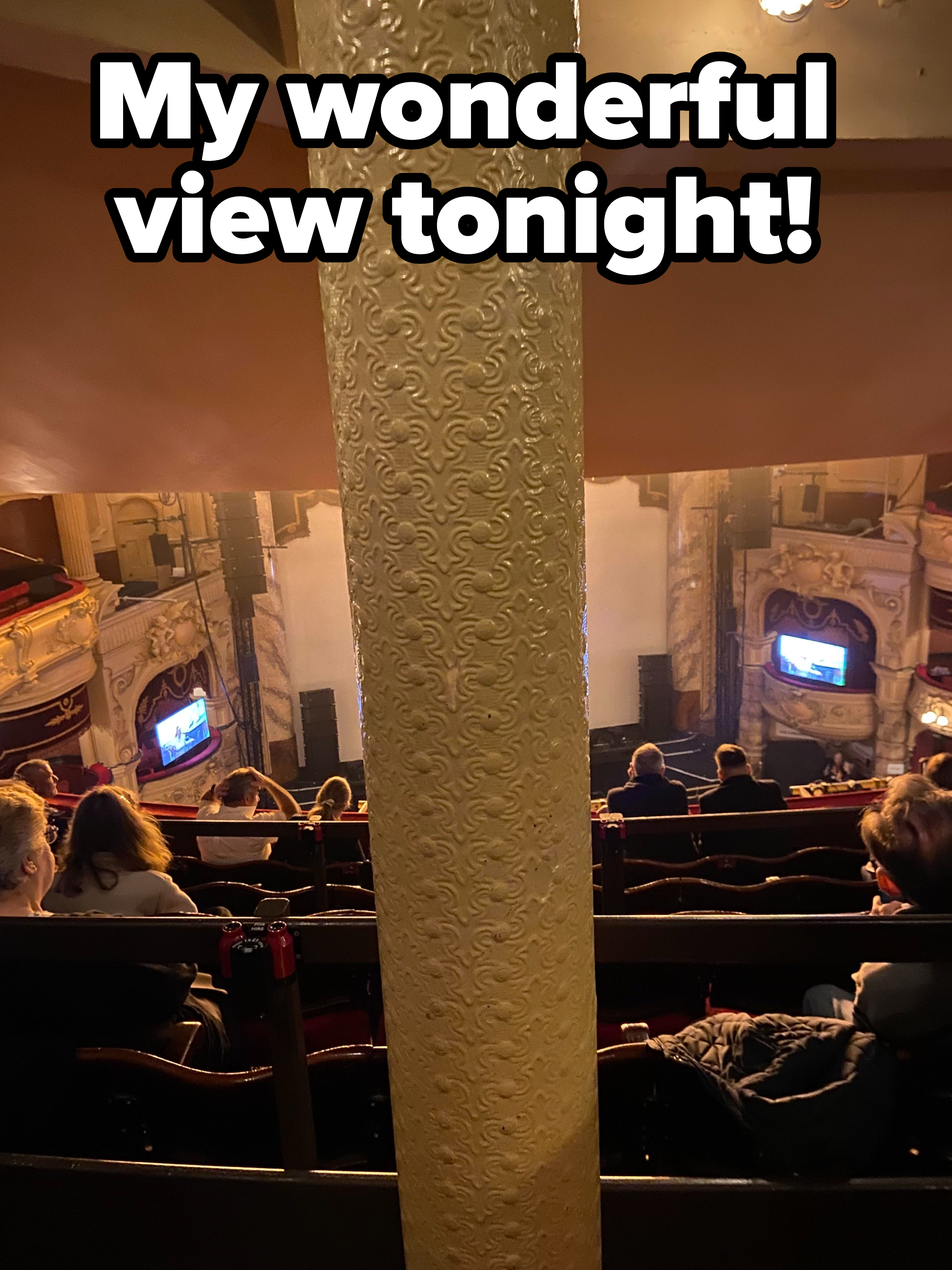 A pole blocking someone&#x27;s view in a theater