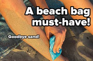 hand using a blue sand-removing bag to clean their leg at the beach