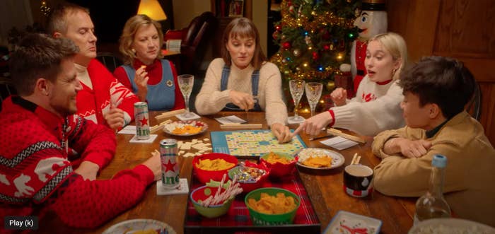 Scene of family playing a board game around a table in EXmas