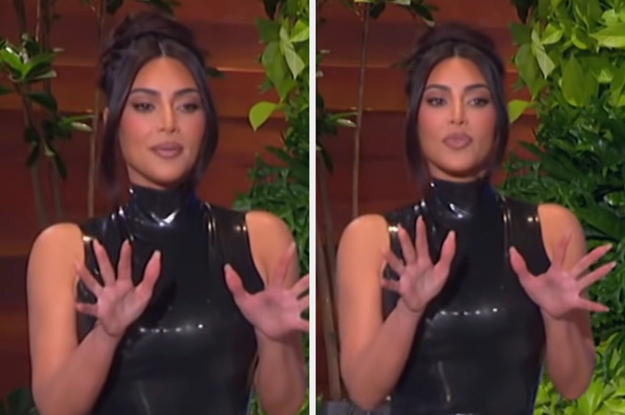 Kim Kardashian puts her hands up defensively as Ellen teases her with a spider