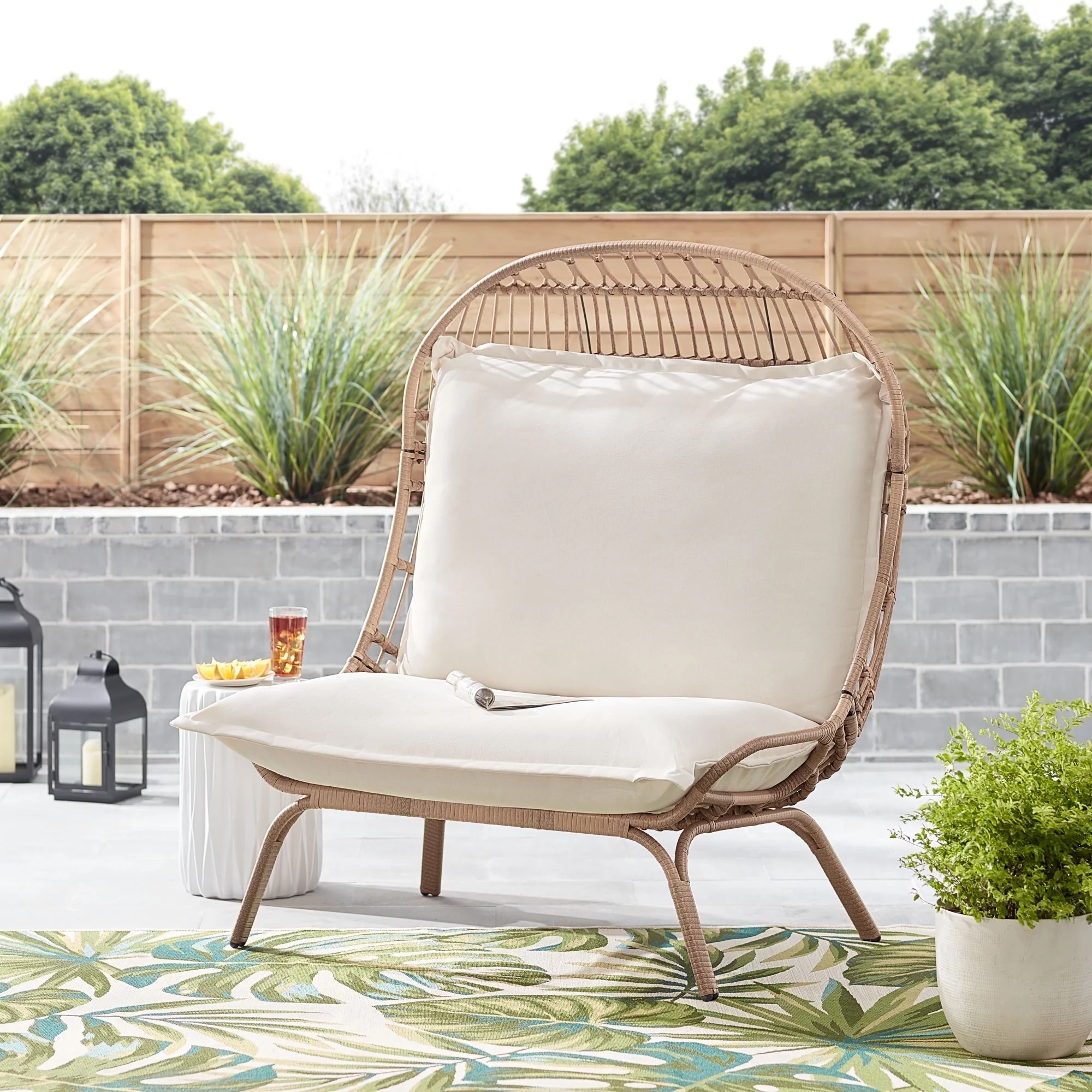 brown wicker patio with white cushions outdoors