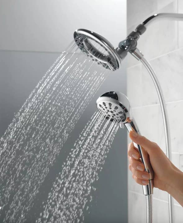 A model holding up the shower head